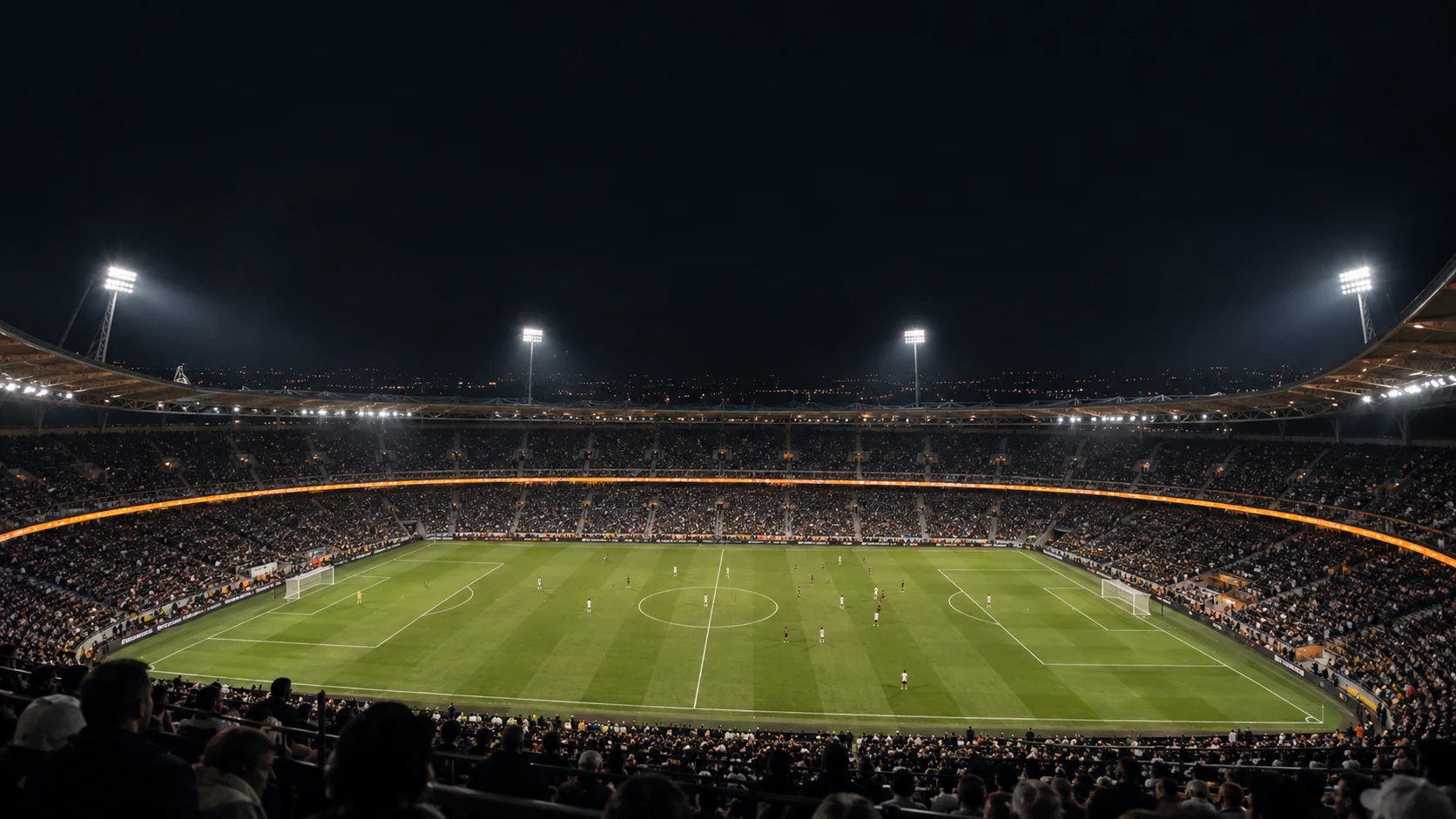Fans at a floodlit football stadium